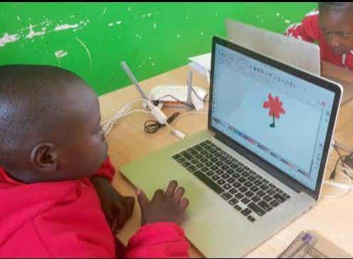 Grade 2 student drawing a house on a computer