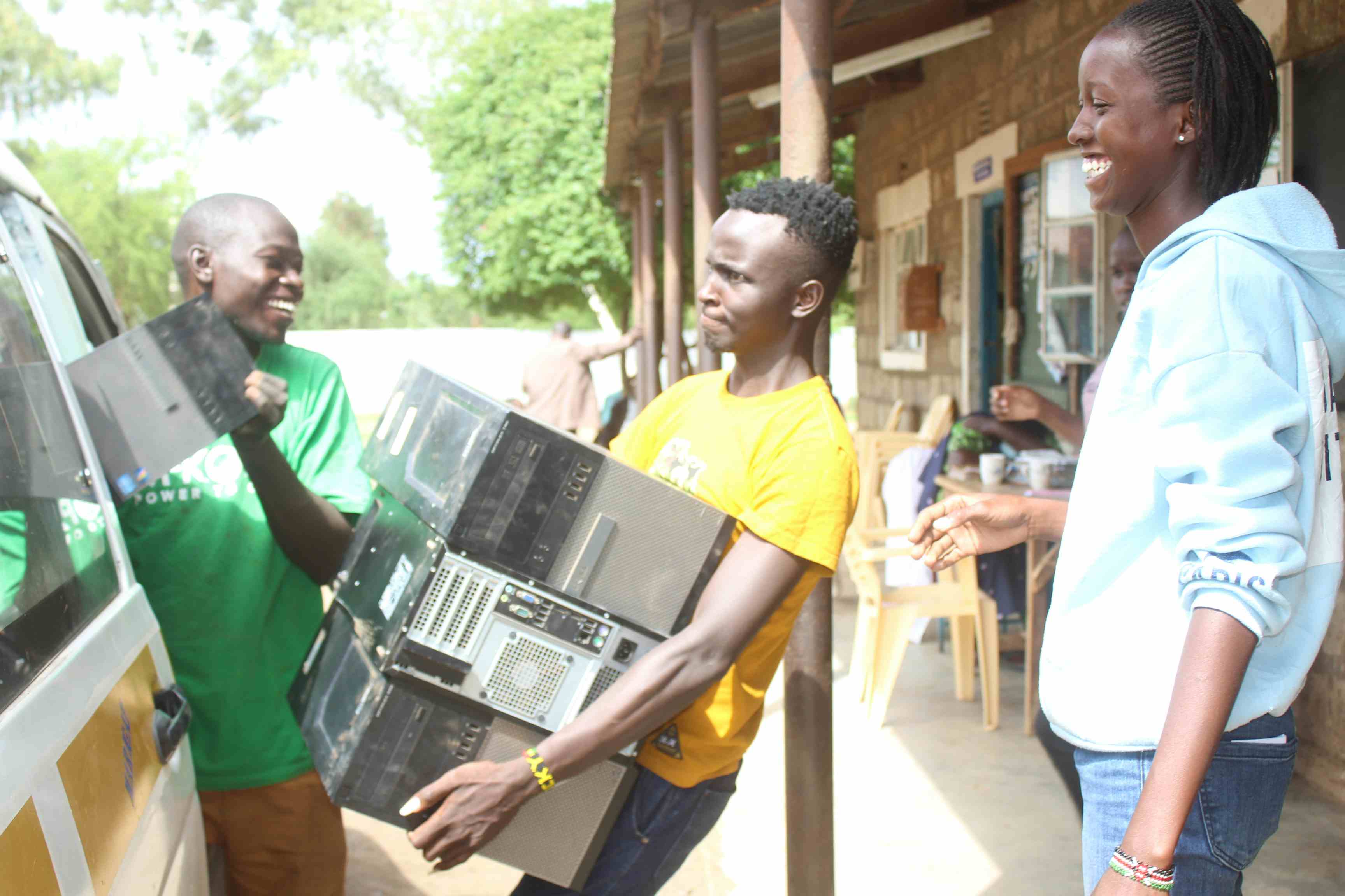 Collins Rocky,Amos Chesire And Jacky Tanui Unloading Donated Computers At Mogotio Primary