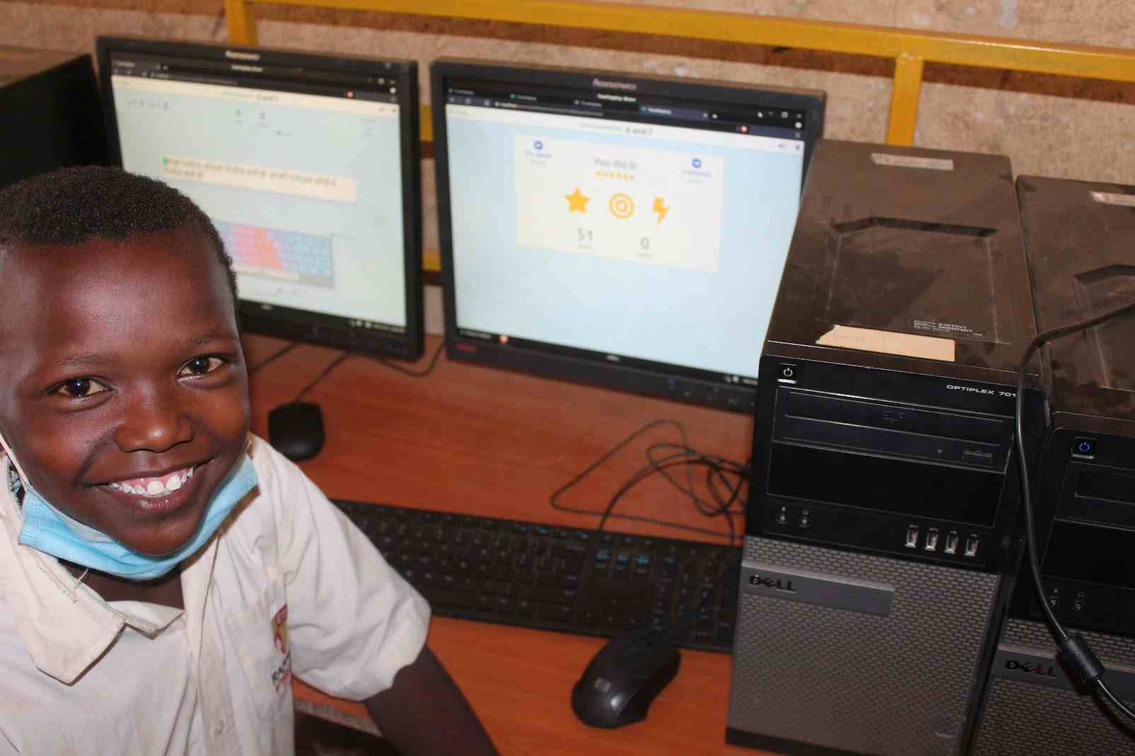 Proud kid touchtyping on a donated computer
