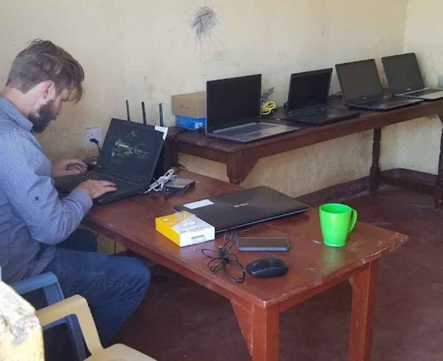 TechLit founder Tyler configuring a school classroom