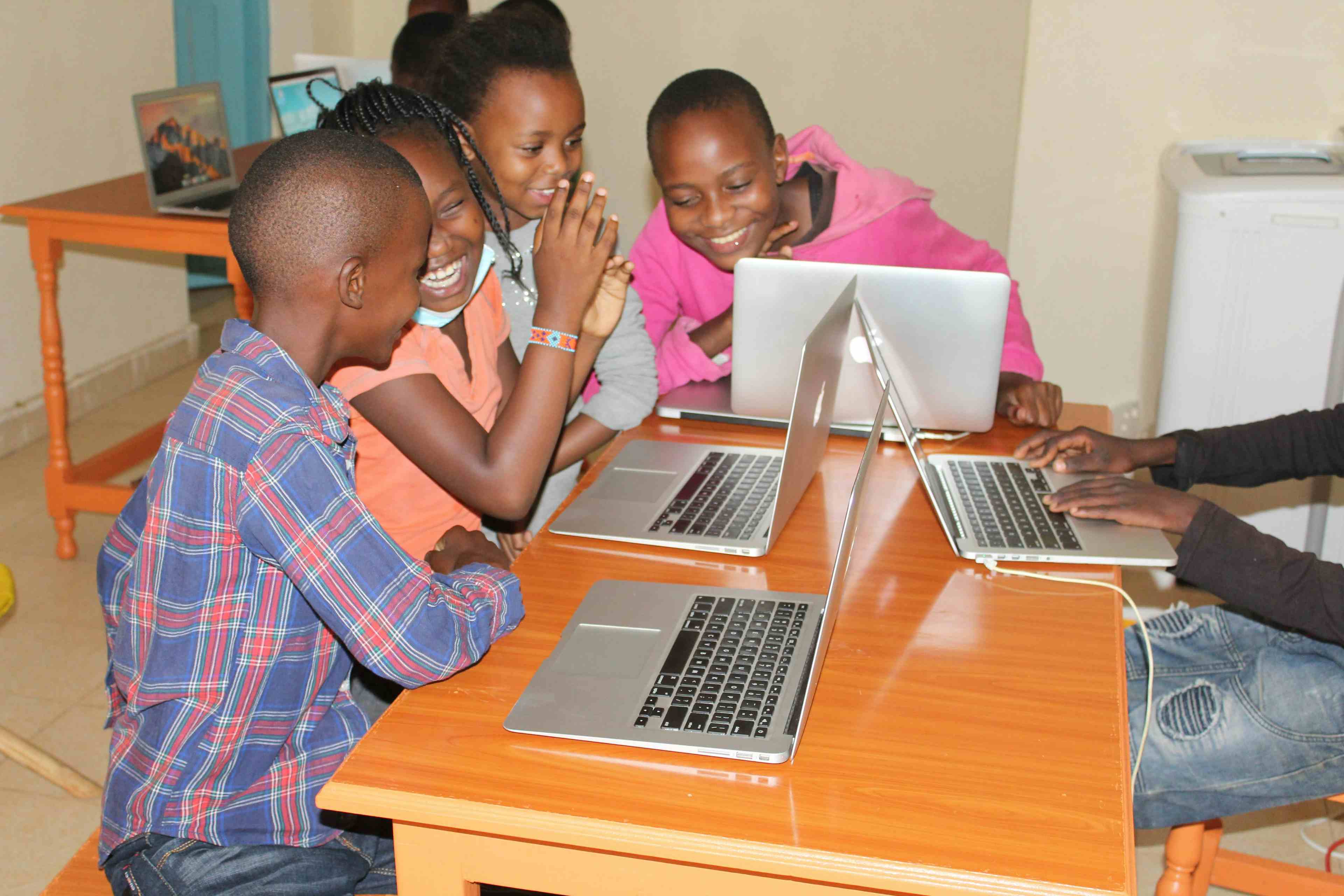 Techlit Kids Sitting At Desk With Computers at an Open Lab in Nelly Cheboi's apartment in Mogotio Kenya