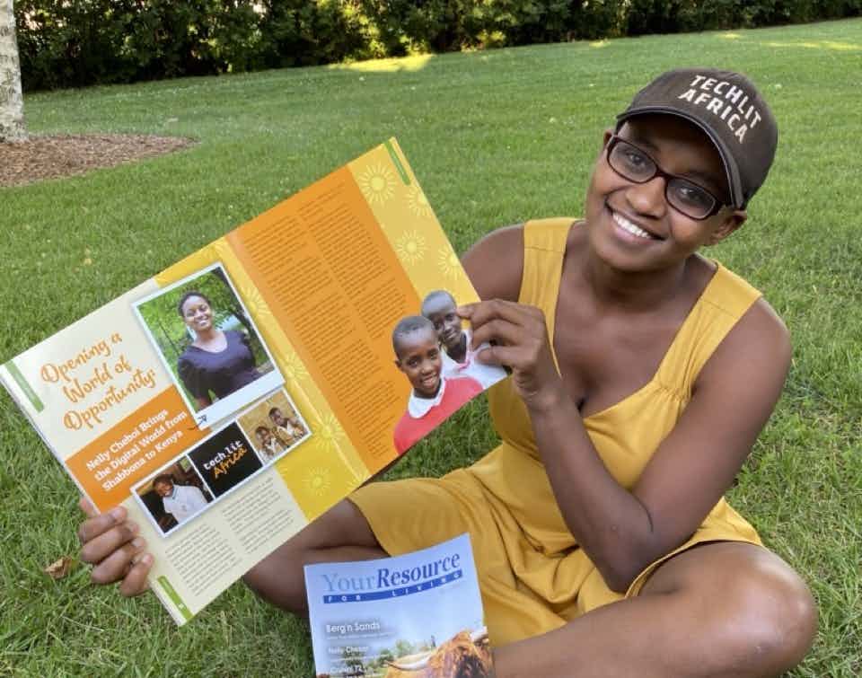 Nelly Cheboi holding an article from Resource Bank