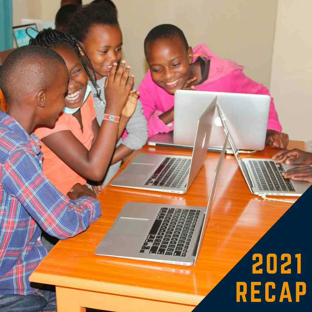 Young children excited learning together with repurposed macbook laptops